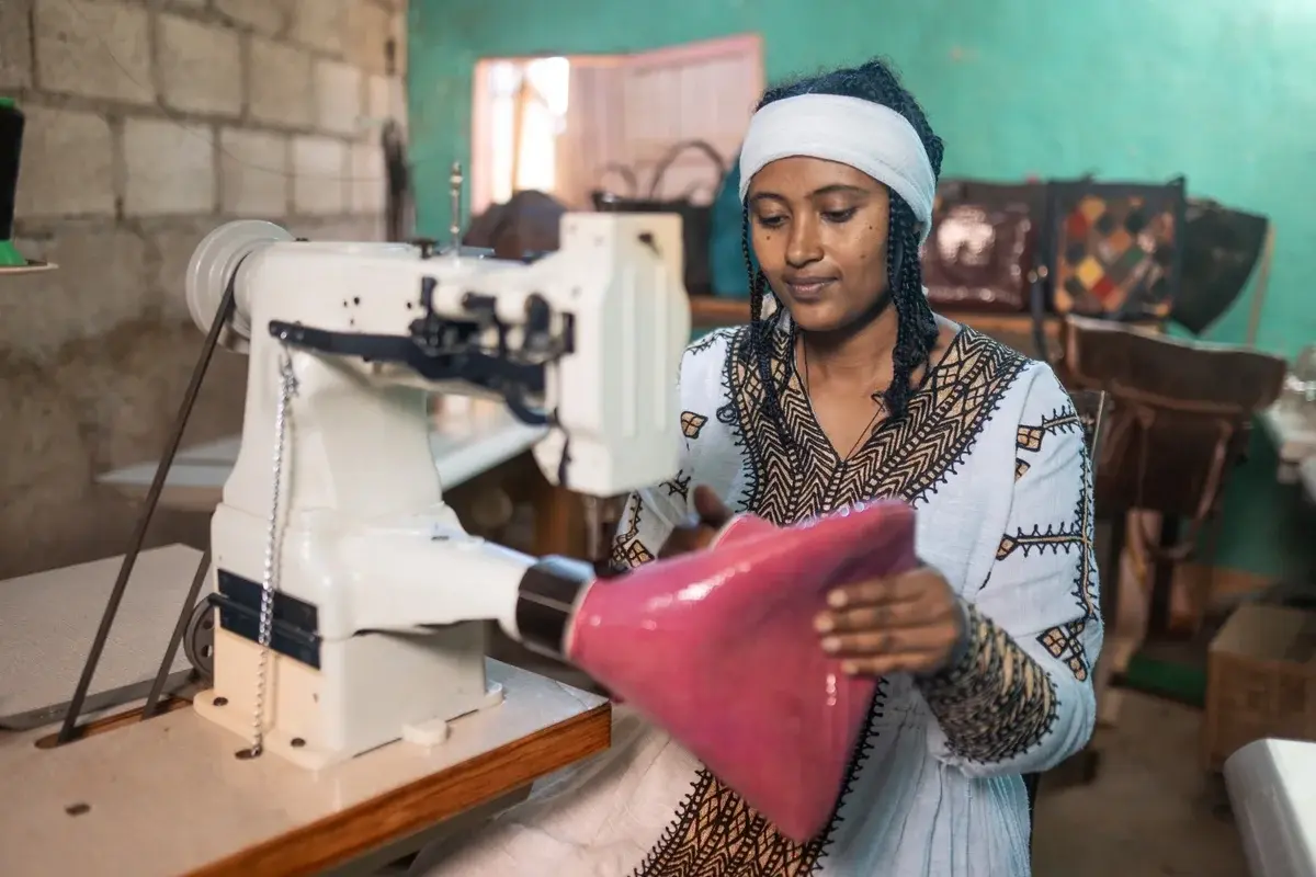 Young woman sewing on a sewing machine